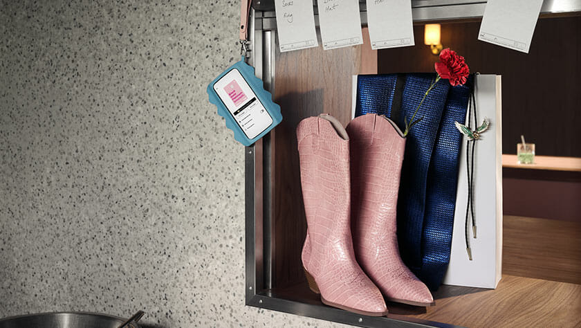 Pink cowboy boots with Klarna app on phone