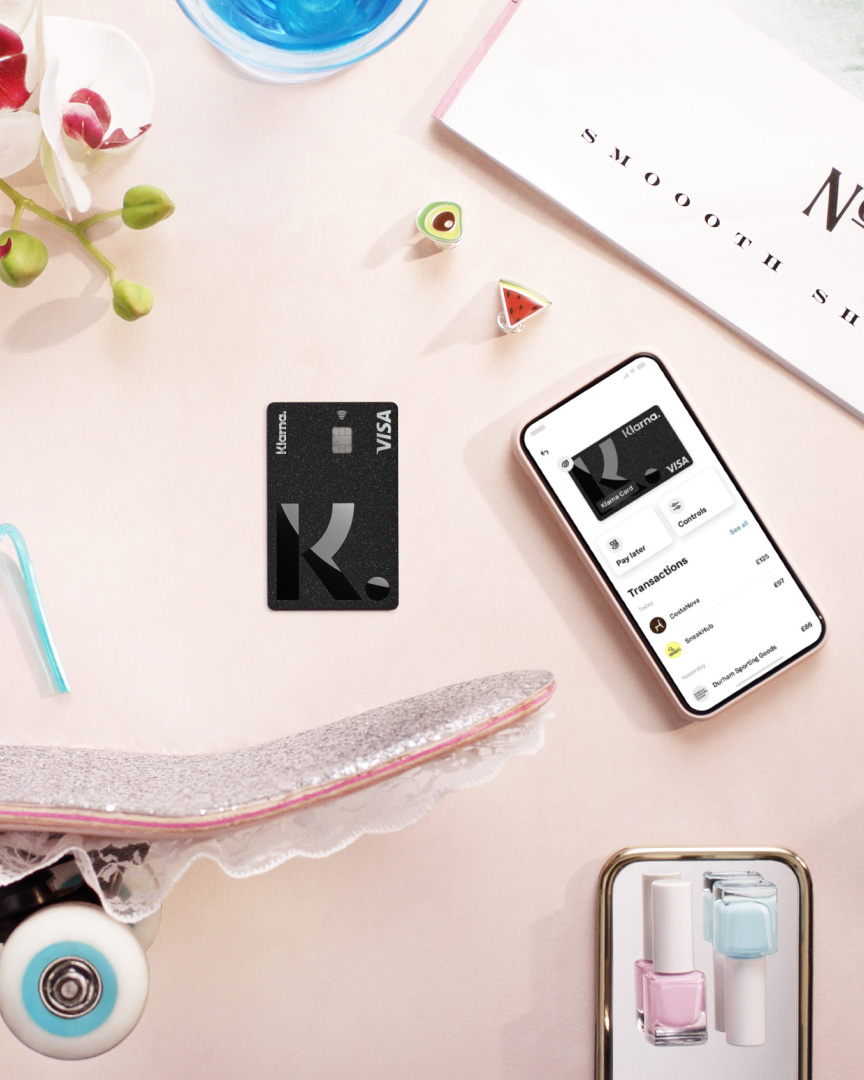 Miscellaneous objects surround the Klarna Card.