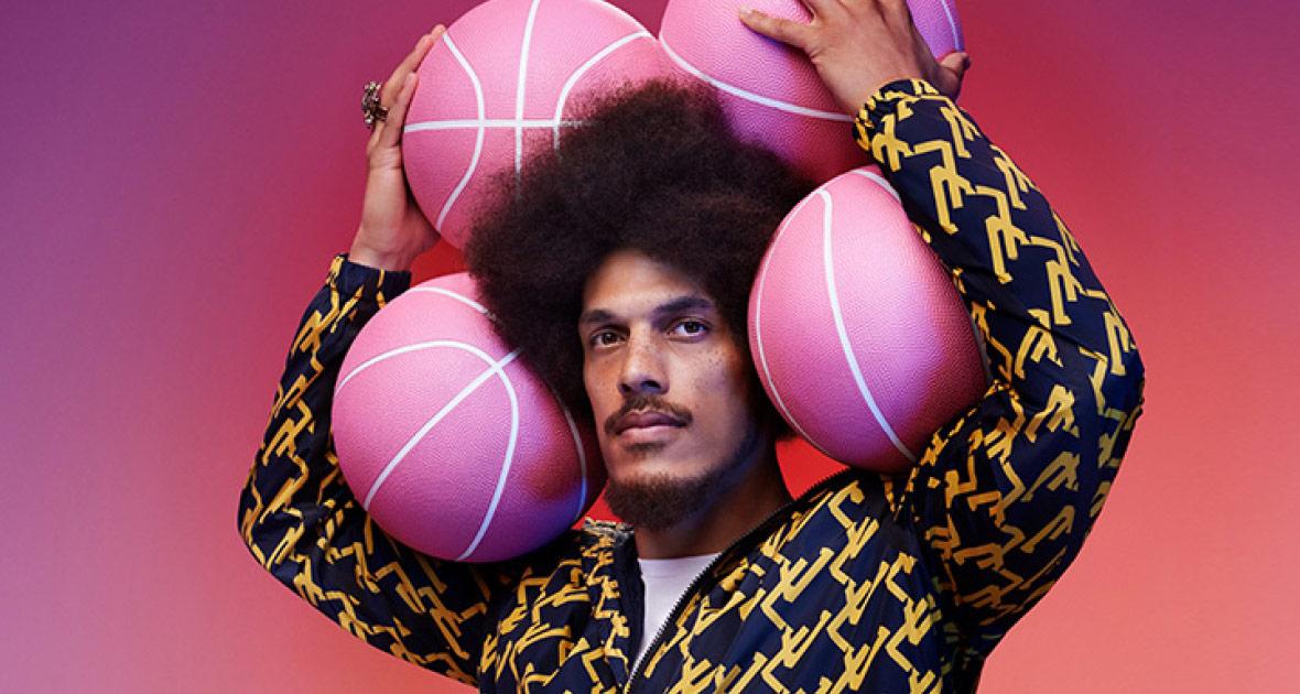 Man holding four pink basketballs